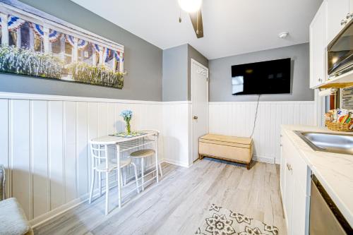 a kitchen with a small table and a tv at Charming Geneva Vacation Rental about 5 Mi to Lake! in Geneva