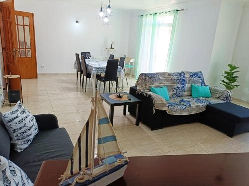 a living room with a couch and a table at Casa Besugo in Sesimbra
