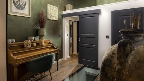 a bedroom with a piano next to a door at Shanti Dubrovnik in Dubrovnik