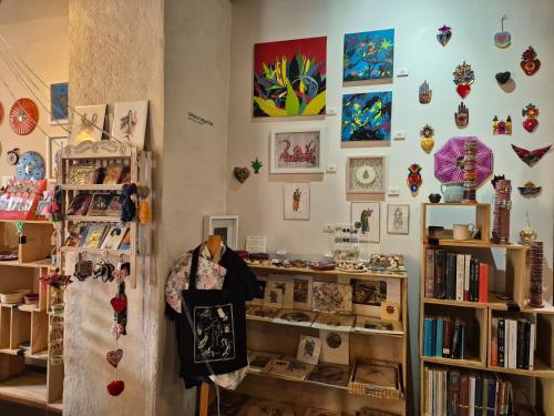 a room with a book shelf with items on it at Pórtico Hotel & Galería in Morelia