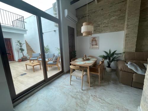 a living room with a table and a couch at Dream Big with jacuzzi and terrace in Ruzafa in Valencia