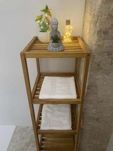 a wooden shelf with towels and a statue on it at Dream Big with jacuzzi and terrace in Ruzafa in Valencia