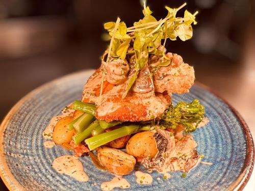 a blue plate of food with vegetables on it at The Mill House Hotel in Buckie