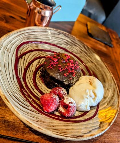 a plate of food on a wooden table at The Mill House Hotel in Buckie