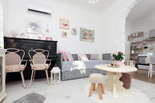 a living room with a bed and chairs and a table at Holiday Home Inga with free private parking in Rijeka