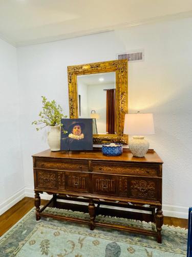 a mirror on top of a dresser in a room at Villa de Siglo-Century Villa in Abilene