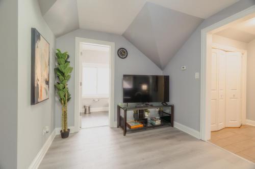 a living room with a flat screen tv and a table at Relaxing Retreat in the Heart of Lombard With Laundry in Lombard