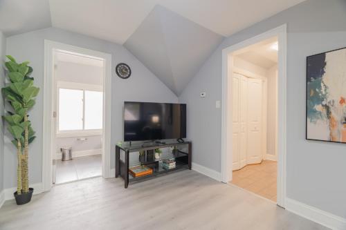 a living room with a flat screen tv and a table at Relaxing Retreat in the Heart of Lombard With Laundry in Lombard