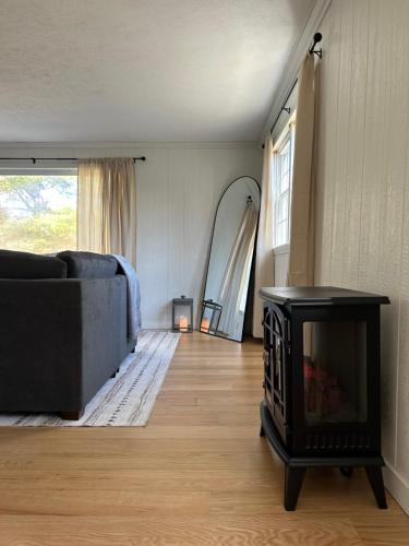 a living room with a fireplace and a couch at The House On Kings Corner in Mansfield