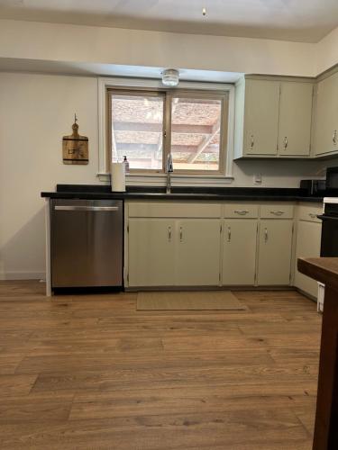 an empty kitchen with a sink and a window at The House On Kings Corner in Mansfield