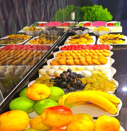 a buffet with many different types of fruit on plates at Hotel By Historia in Istanbul
