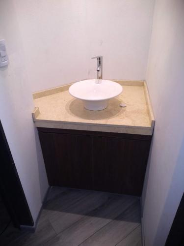 a bathroom with a white sink in a room at Casa en Cabalango in Cavalango