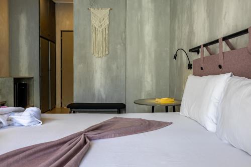 a bedroom with a bed and a table at California Beach Hotel - Adults Only in Laganas