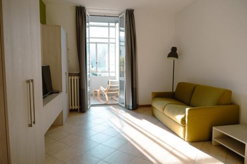 a living room with a couch and a television at Residenza Cece' in Lecco