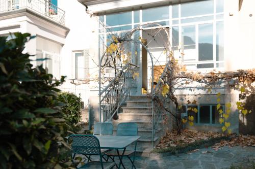 a table and chairs in front of a building at Residenza Cece' in Lecco