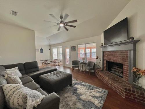a living room with a couch and a fireplace at Pecan Place Rustic Charm Temple Texas in Temple