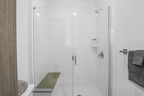 a shower with a glass door in a bathroom at Luxurious New Unit 2Bd2Ba Pool, Golf Sim in Austin