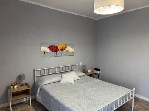 a bedroom with a bed and two paintings on the wall at NEpicentro in Nepi