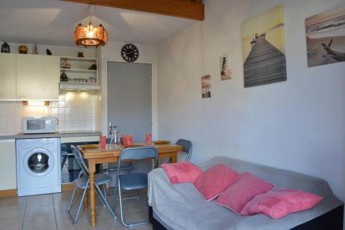 un salon avec un canapé et une table et une cuisine dans l'établissement SP190-119 Maison mezzanine 6 couchages SAINT PIERRE LA MER, à Saint Pierre La Mer