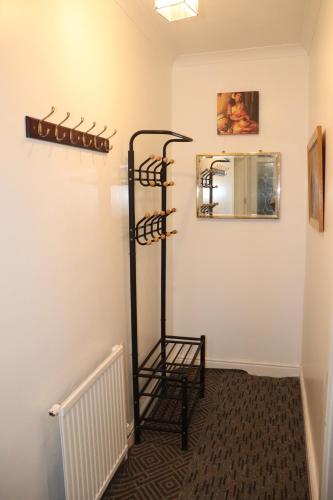 a room with a rack of shoes on the wall at Acaccia Bunglow in Carterton