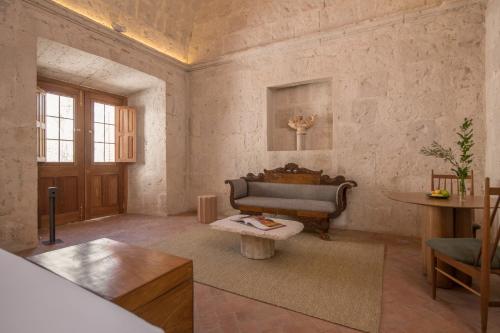a living room with a couch and a table at Palacio Guaqui by Ananay Hotels in Arequipa