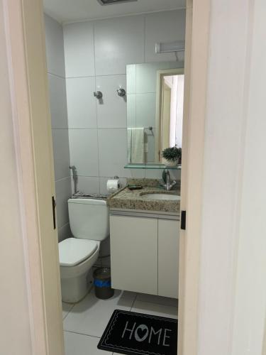 a bathroom with a toilet and a sink and a mirror at HOTEL TAMBAÚ FLAT EXCLUSIVE apt particular in João Pessoa