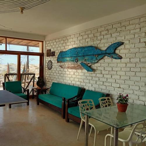 a living room with a blue fish on the wall at Punta Vichayo - Casa Ballenas in Talara