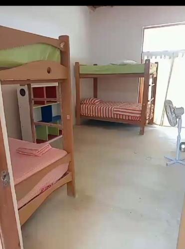 a room with two bunk beds and a window at Punta Vichayo - Casa Ballenas in Talara