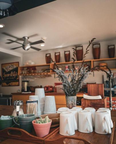 a table with cups and plates and a ceiling fan at The Astro in Santa Rosa