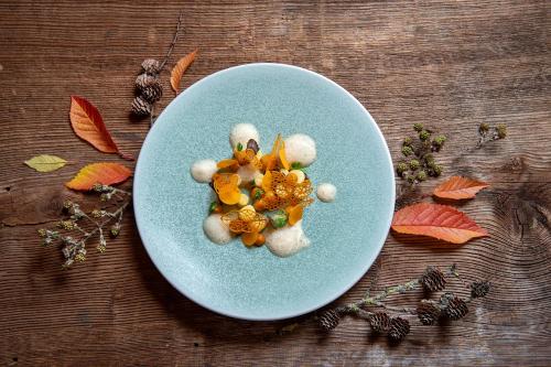 a blue plate with christmas decorations on a table at SALZANO Hotel - Spa - Restaurant in Interlaken