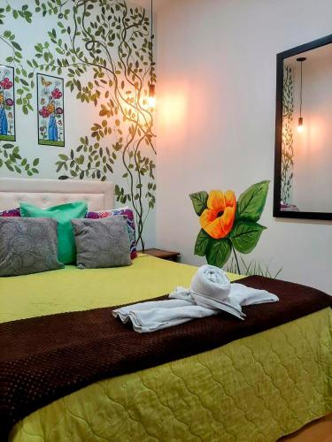 a bedroom with a bed with towels on it at Hotel Boutique Stay La 10 in Medellín