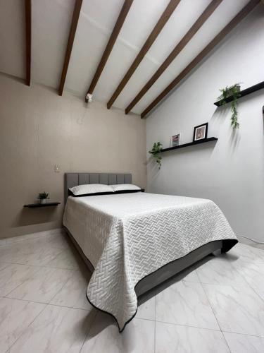 a bedroom with a large bed in a room at Apartamento en Laureles Medellin in Medellín