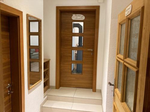 a wooden door in a room with a hallway at Appartment Elfi in Uttendorf