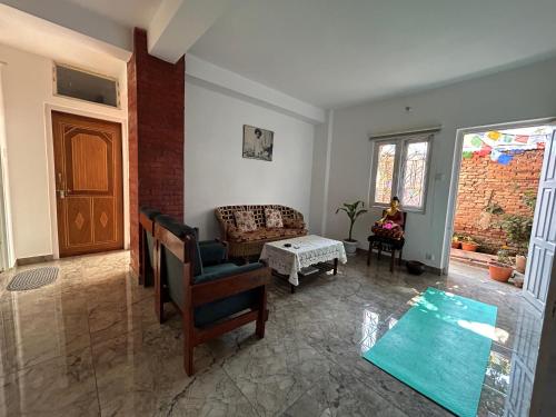a living room with a couch and a chair at Yoga Apartment Near Airport & Pashupatinath 2 BHK in Kathmandu