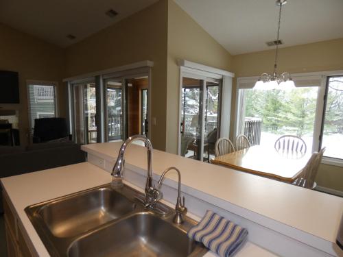 a kitchen with a sink and a counter top at CrossWinds Getaway at Shanty Creek in Bellaire