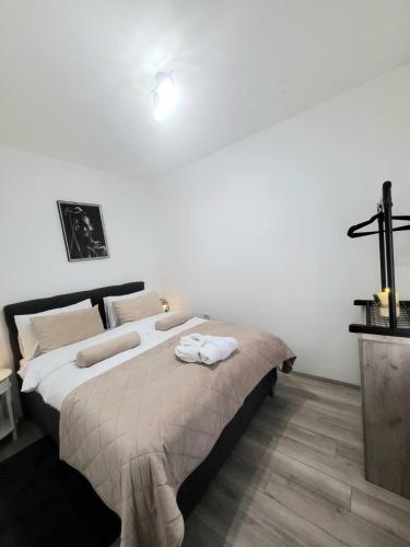 a bedroom with a large bed with towels on it at Apartman N Jagodina in Jagodina