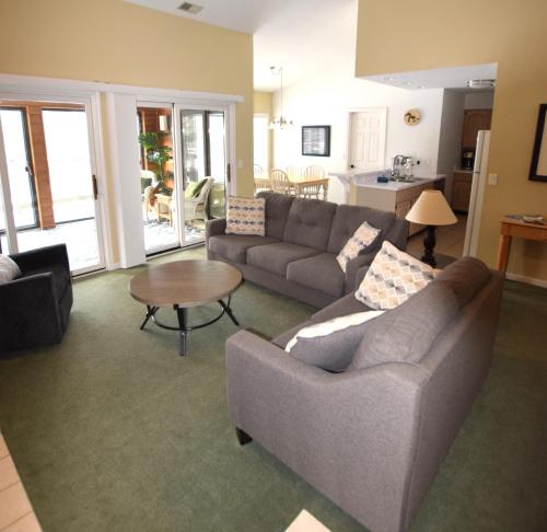 a living room with a couch and a table at CrossWinds Getaway at Shanty Creek in Bellaire