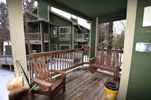 two rocking chairs on a porch of a house at CrossWinds Getaway at Shanty Creek in Bellaire