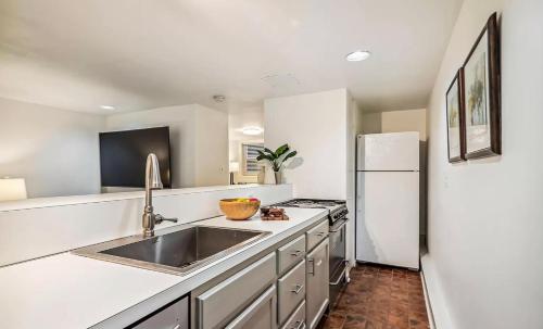a kitchen with a sink and a refrigerator at Historic Capitol Hill Retreat in Washington, D.C.