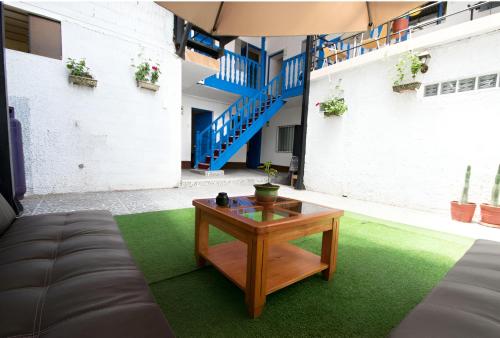 a living room with a table and a couch at Magnolia Andina in Cusco