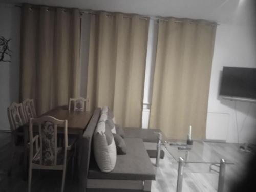 a living room with a couch and a table at BORNE militaria wygodne mieszkanei dla 5 osób in Borne Sulinowo