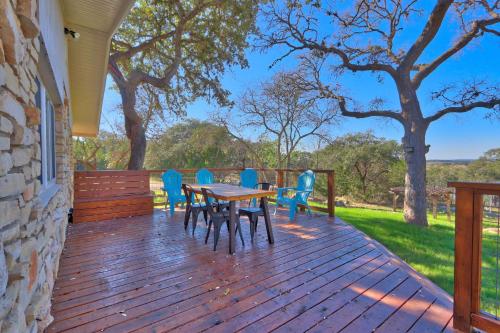 a wooden deck with a table and chairs on it at Millie's Cottages Unit 1 - Ruth in Canyon Lake