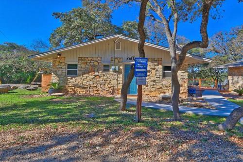 a house with a blue sign in front of it at Millie's Cottages Unit 1 - Ruth in Canyon Lake