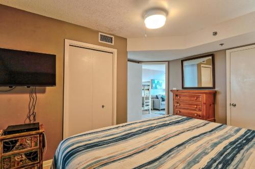 a bedroom with a bed and a flat screen tv at Phoenix V 902 in Orange Beach