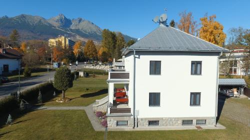 an aerial view of a white house with a roof at Vila Malá Marta in Tatranská Lomnica