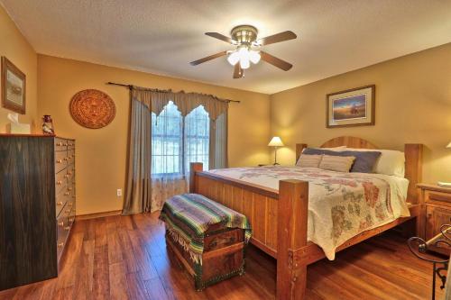 a bedroom with a bed and a ceiling fan at Honky Tonk Getaway in Driftwood