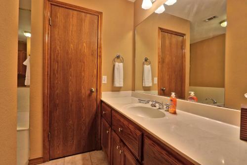 a bathroom with a sink and a large mirror at Honky Tonk Getaway in Driftwood