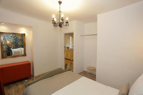 a bedroom with a bed and a chandelier at Union Square Apartment by NUX in Cluj-Napoca