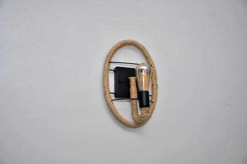 a rope hooked up to a lighter on a wall at Elegant Studio with Rooftop Pool in Nairobi -Jovial Homes in Kiambu