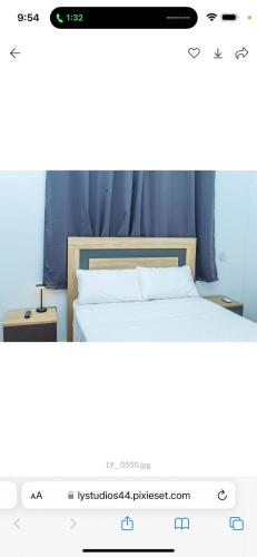 a screenshot of a bedroom with a bed in a room at Hotel Mandarin in Accra